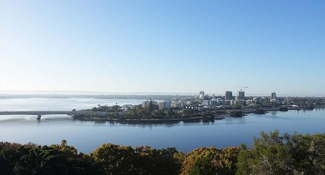 image of a landscape showing land, water and city